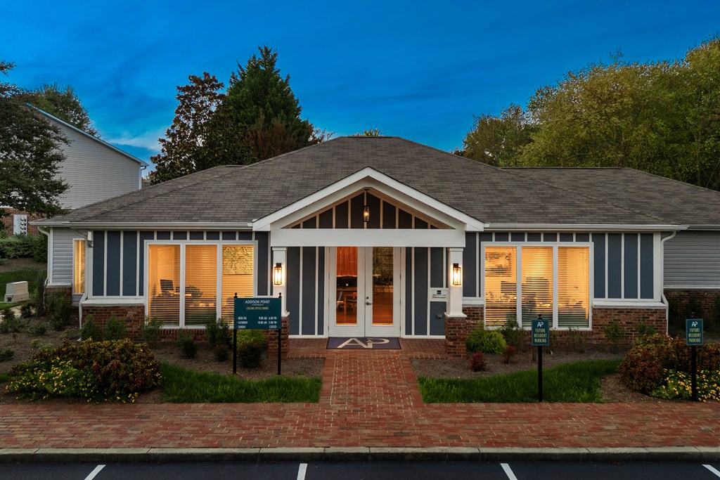 A house with a brick walkway leading to the front door.