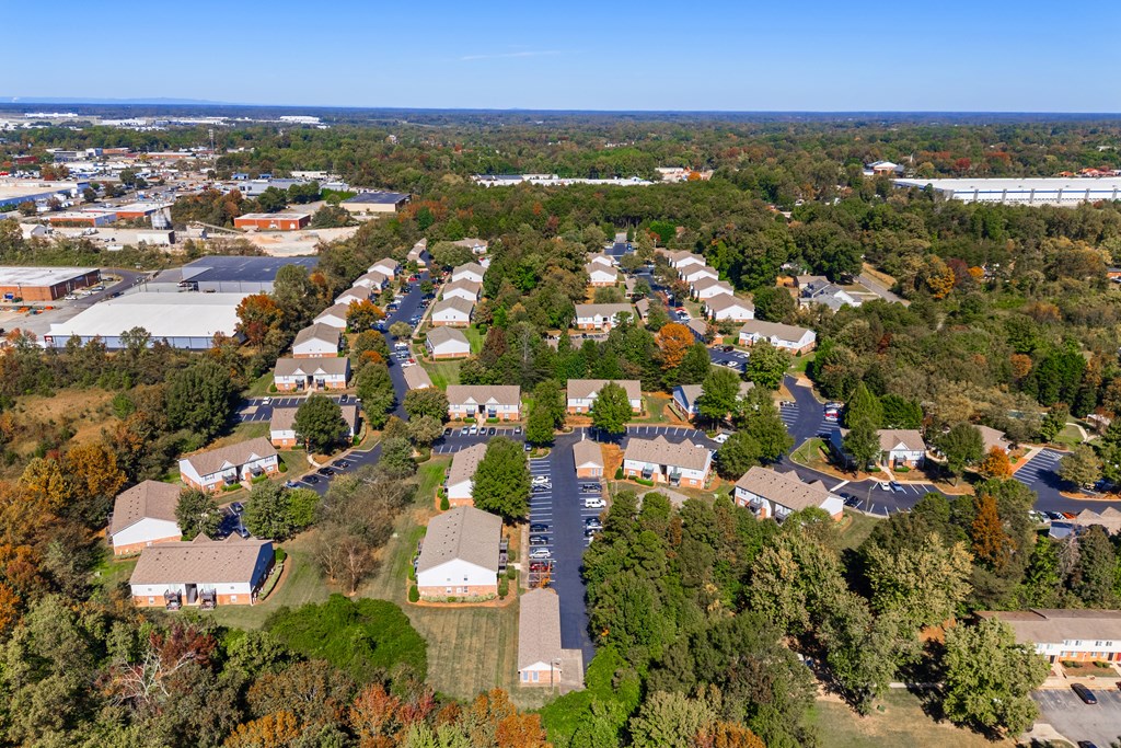 A bird's eye view of a residential area with houses and trees.
