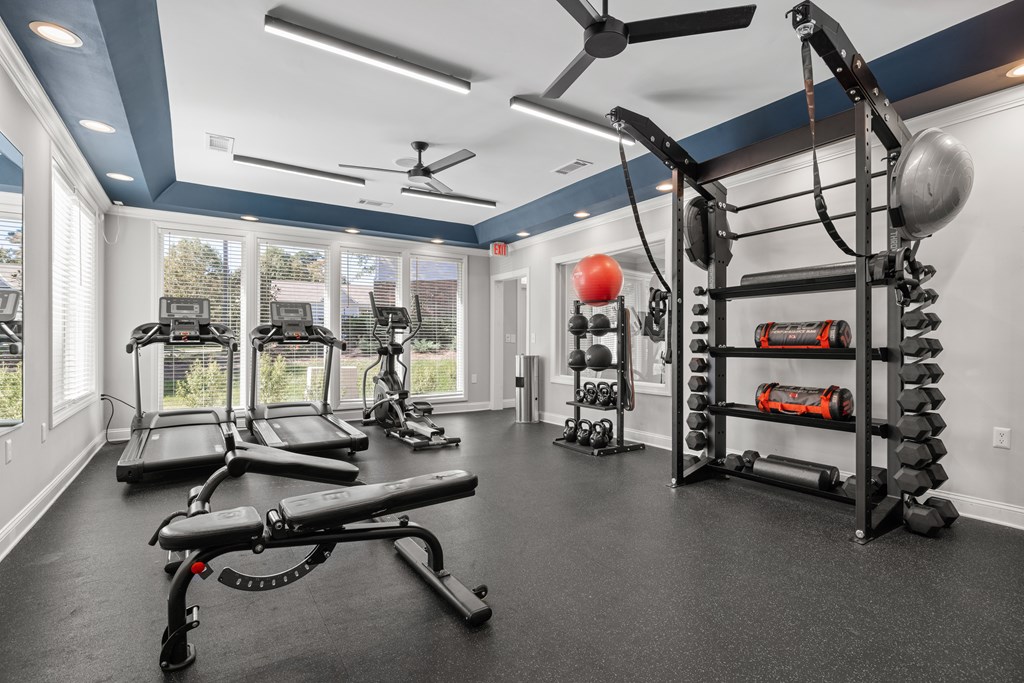 A spacious home gym with a variety of exercise equipment.