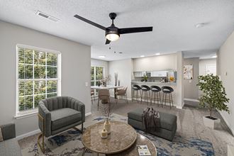 an open living room and kitchen with a ceiling fan