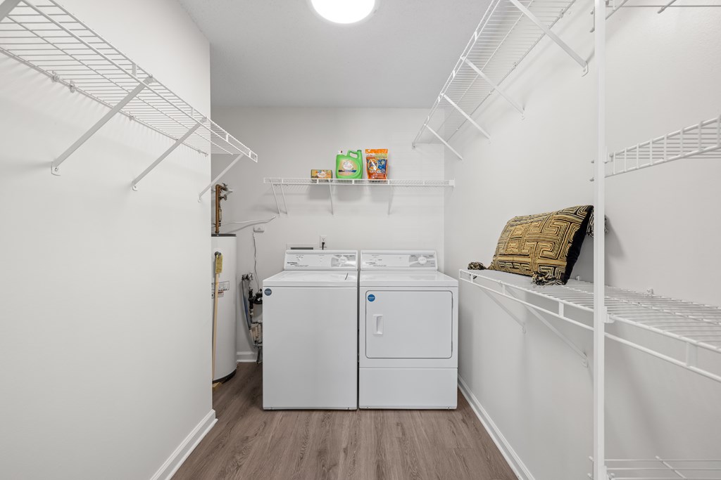 A small white laundry room with a washer and dryer.