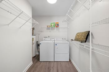 A small white laundry room with a washer and dryer.