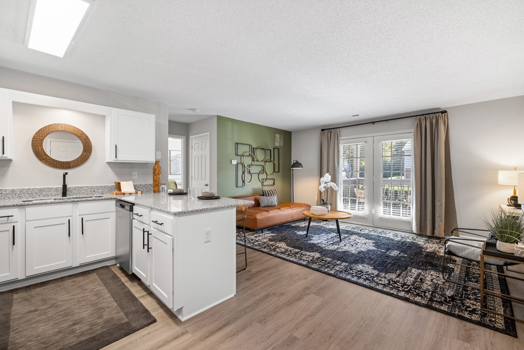 A modern kitchen with white cabinets and a large island.