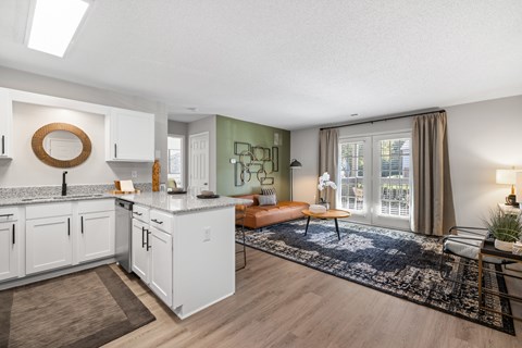 A modern kitchen with white cabinets and a large island.