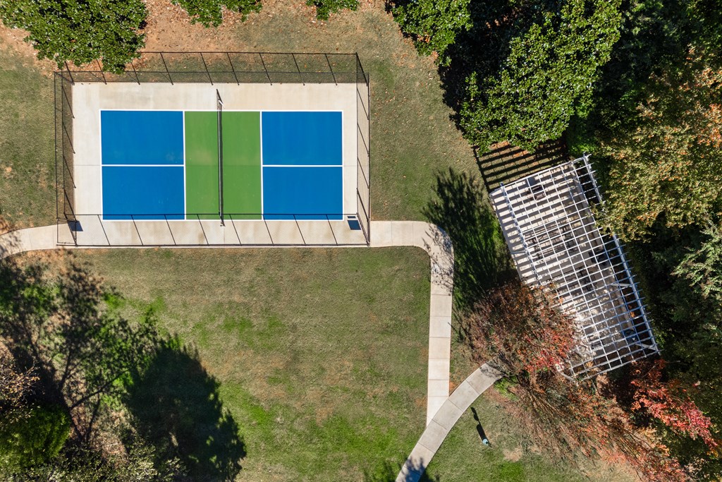 A swimming pool surrounded by trees and a solar panel.
