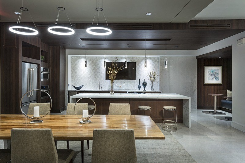 A modern dining room with a wooden table and chairs.