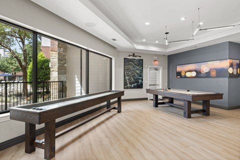 A room with a pool table and a bench.