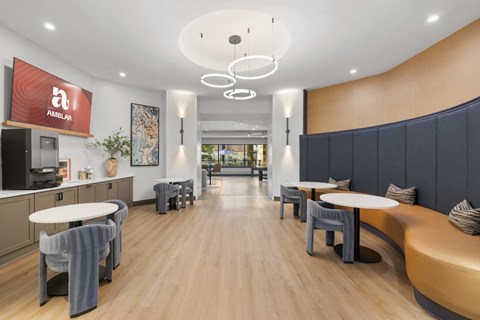 A modern dining area with wooden floors and a mix of white and dark grey furniture.