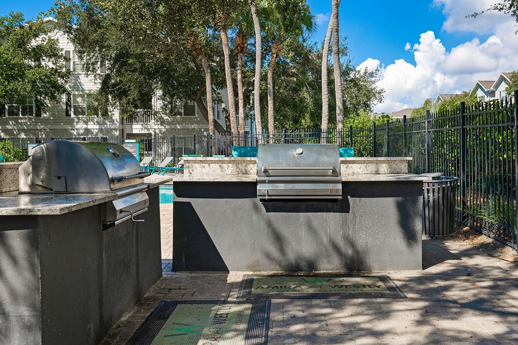 A concrete structure with a metal grate in front of it.