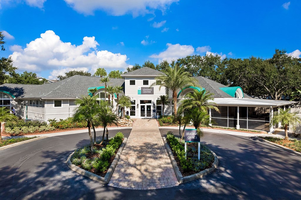 A sunny day at the entrance of a residential area with a sign that says "FARM".