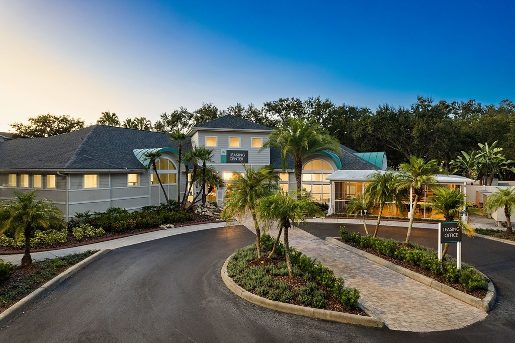 A resort with a driveway leading to the main building.