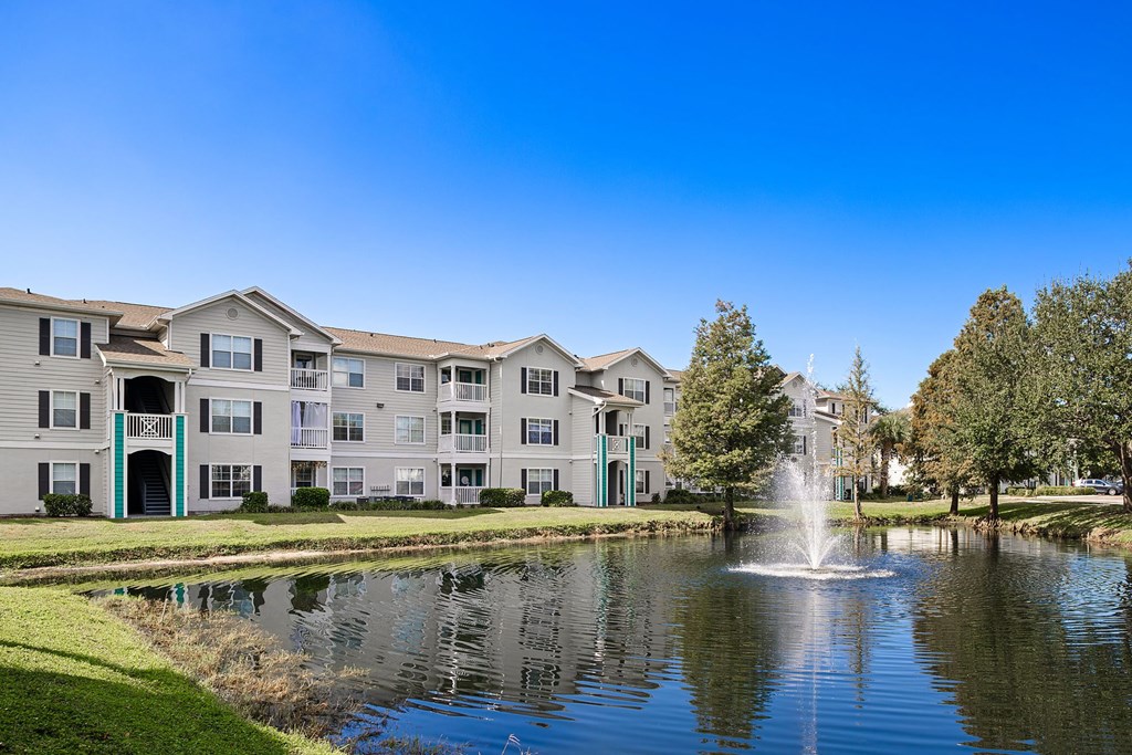A fountain in front of apartment buildings.