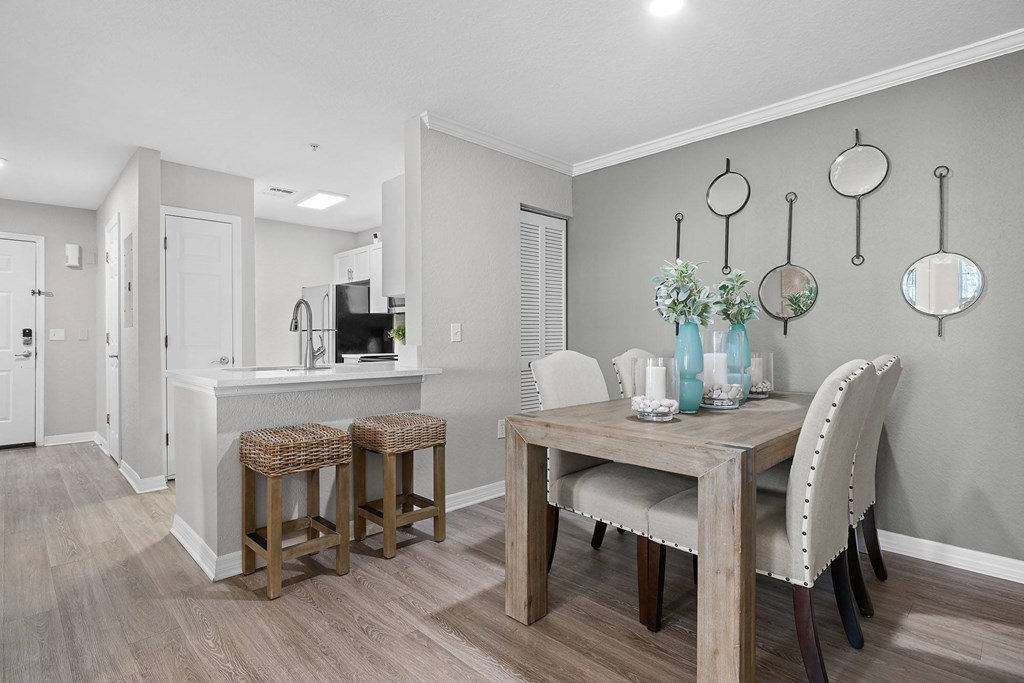 A kitchen with a table and chairs.