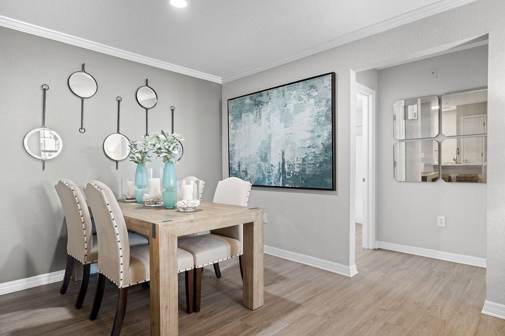 A dining room with a wooden table and chairs.