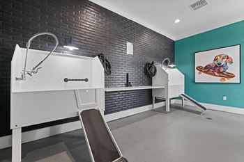 A room with a treadmill, bench, and a painting on the wall.