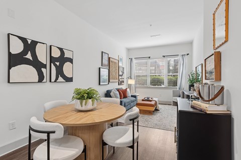 A modern dining room with a round table and chairs.