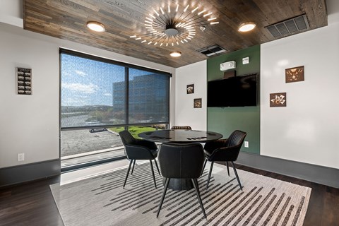A modern dining room with a round table and chairs.