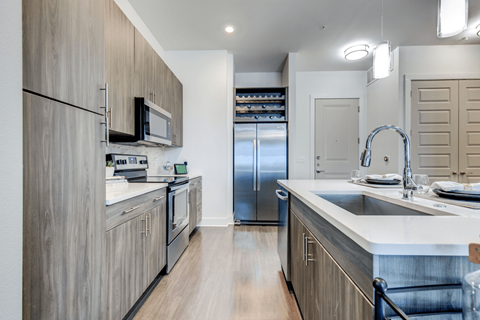 A modern kitchen with wooden cabinets and stainless steel appliances.