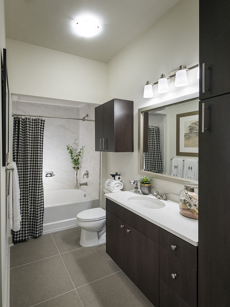 A bathroom with a toilet, sink, and shower.