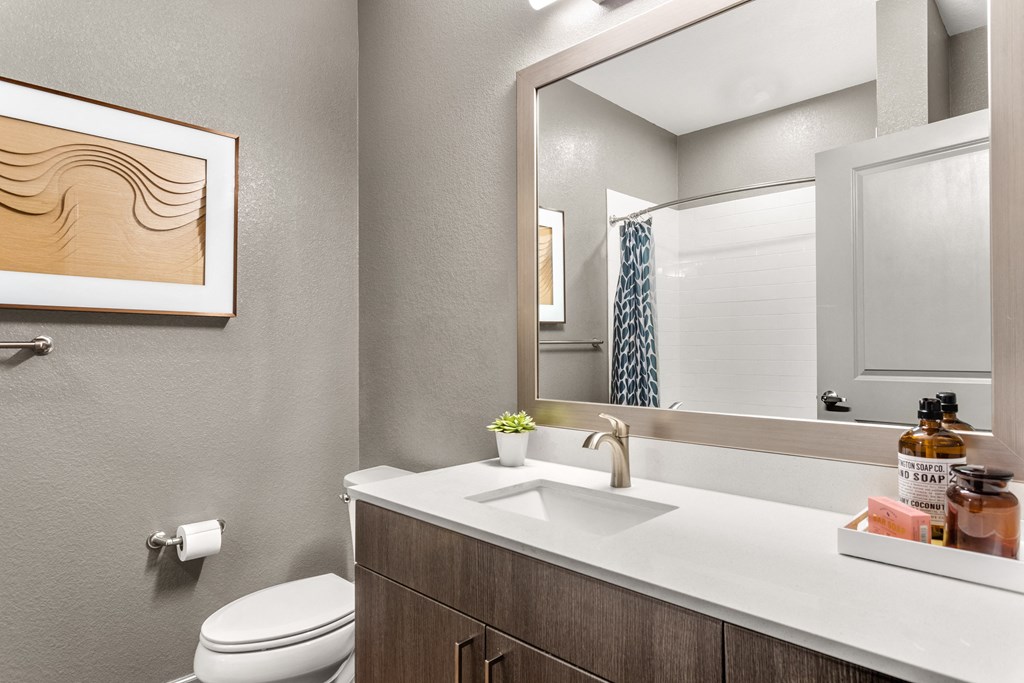 ensuite bathroom with toilet and sink at the district flats apartments