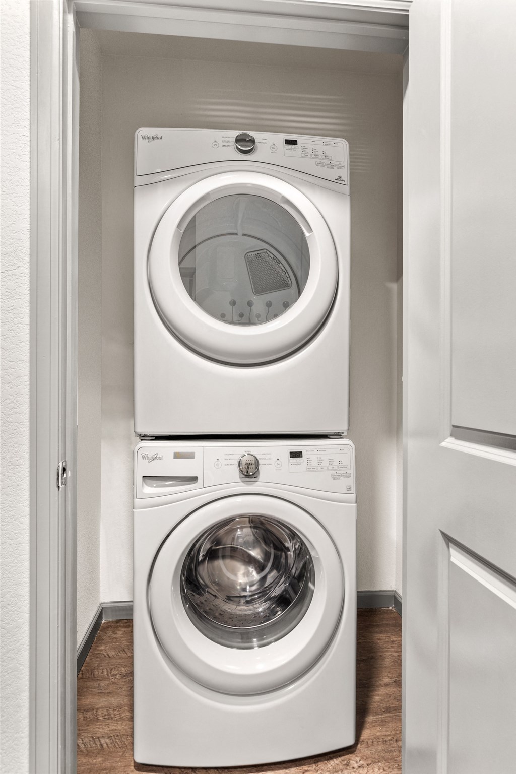 a white washer and dryer in a small laundry room