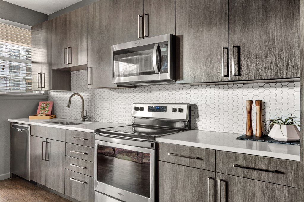 a kitchen with stainless steel appliances and a microwave