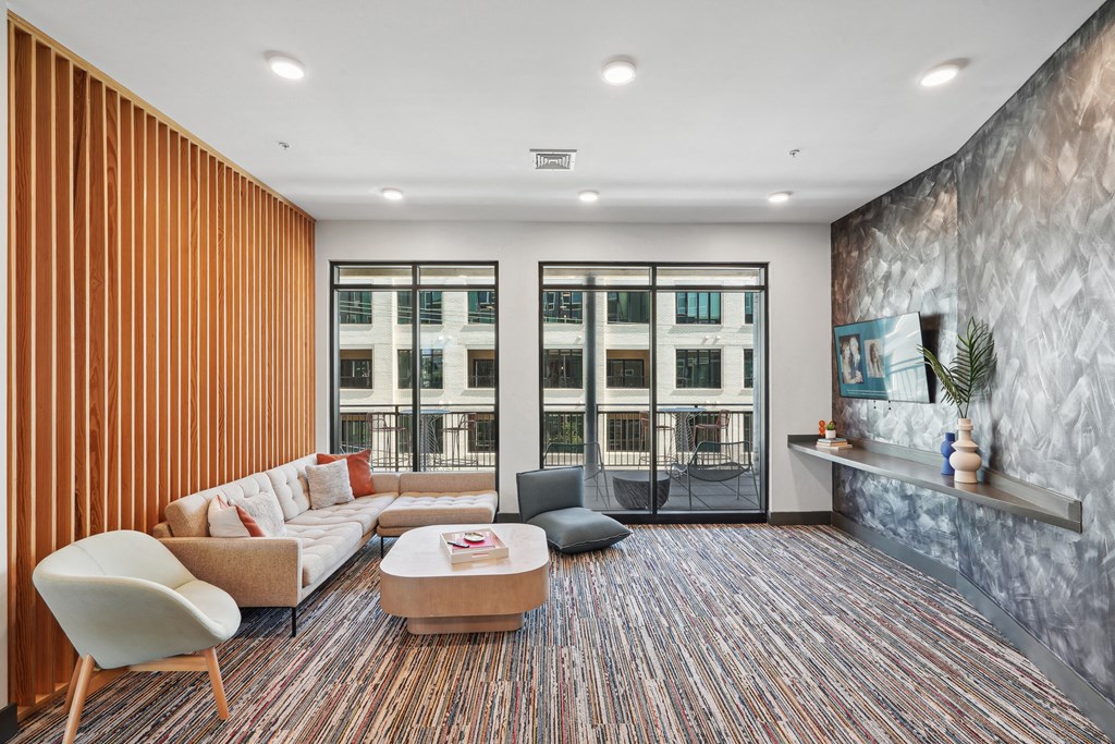 a living room with a couch and a table     and a balcony