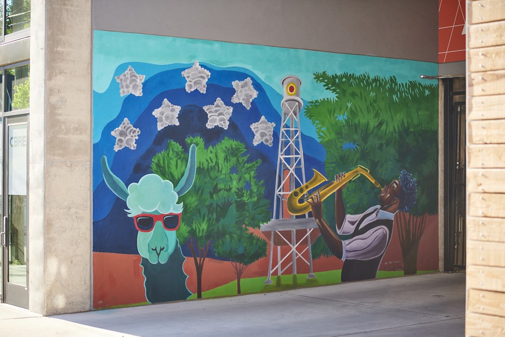 a mural on the side of a building with a person playing a trumpet and a