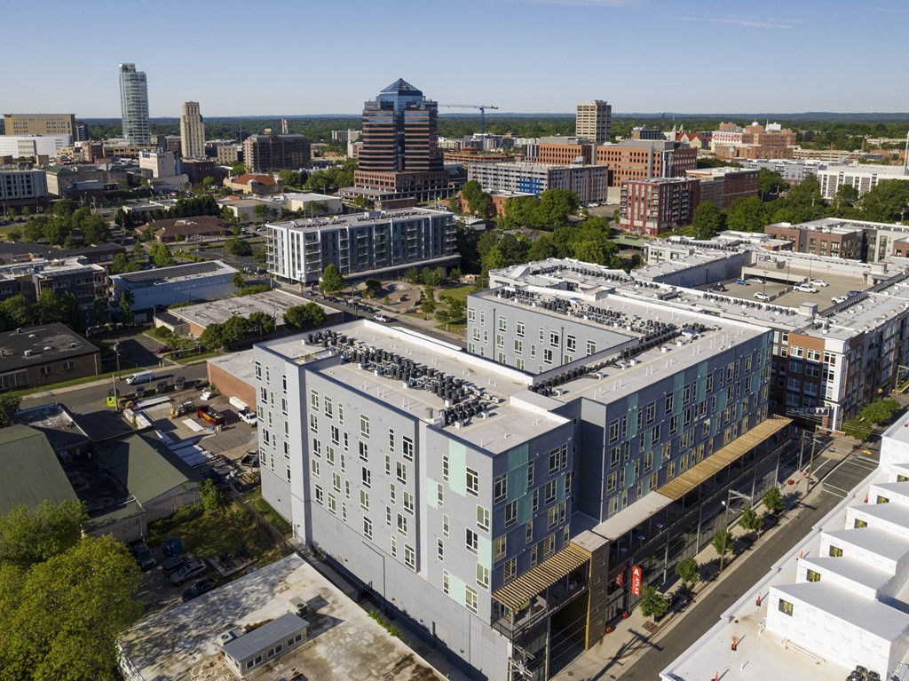an aerial view of an urban city with a large building with a roof and a