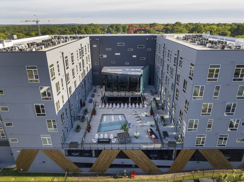 an aerial view of a building with a pool and a convention center