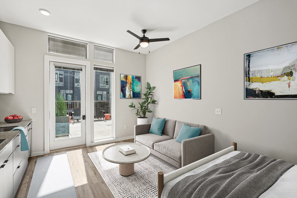 a living room with a couch and a ceiling fan