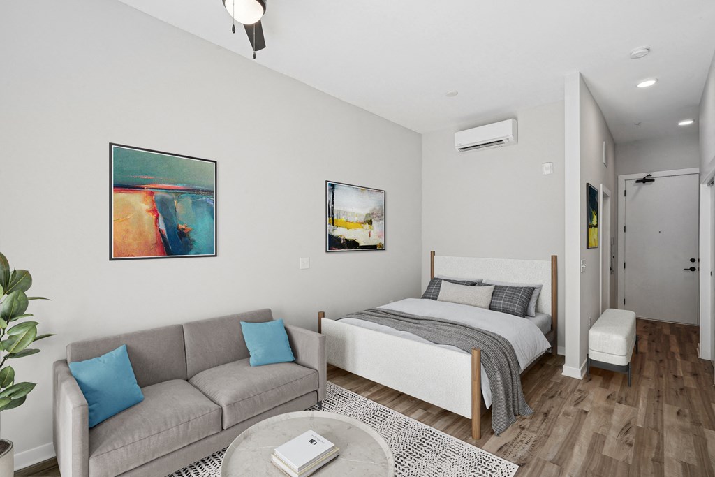 a living room with a couch and a bed