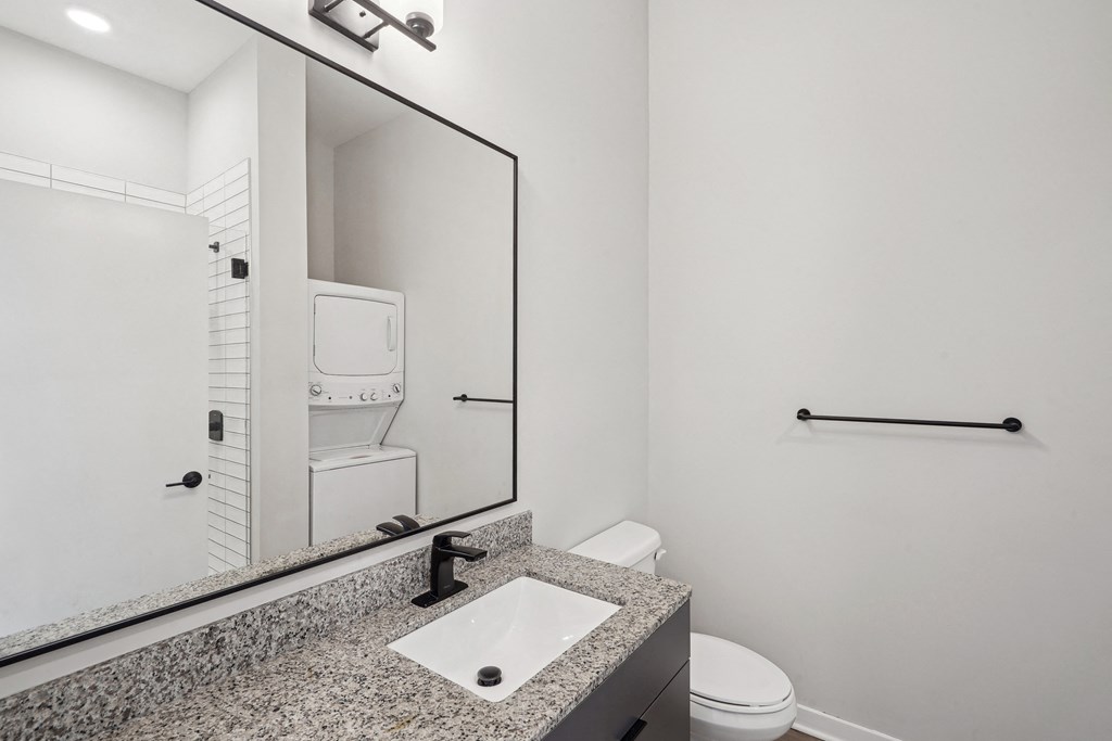 a bathroom with a sink and a toilet and a mirror