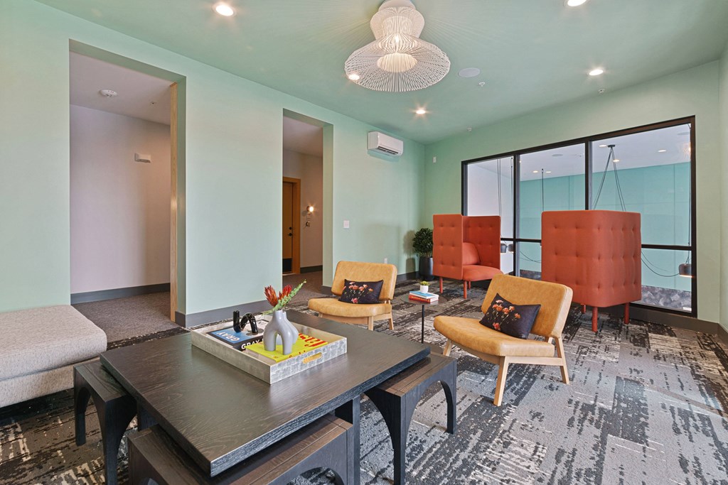 a living room with blue walls and a table and chairs