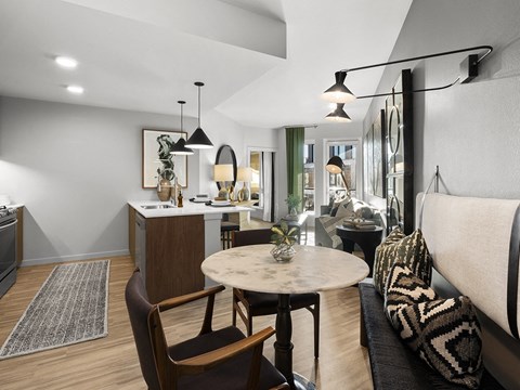 a living room and kitchen area with a dining table and a couch