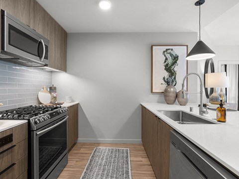 a kitchen with stainless steel appliances and a white counter top