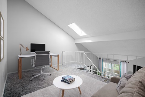 A modern living room with a grey sofa and a white coffee table.