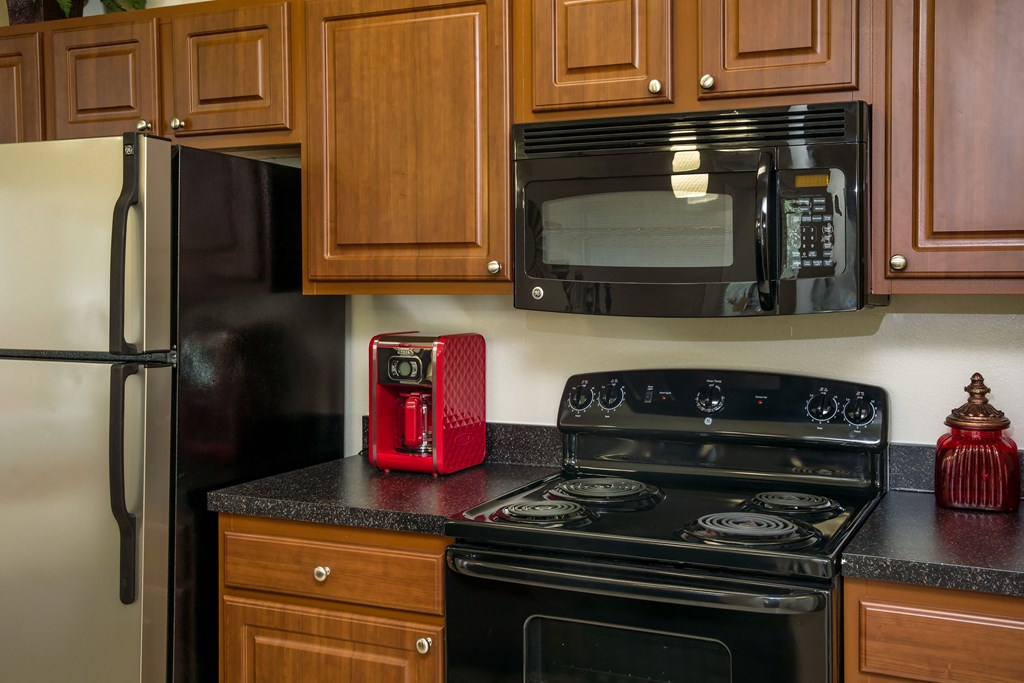 a kitchen with a stove microwave and refrigerator