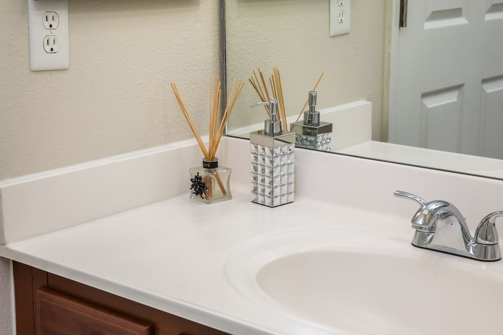 a bathroom sink with white counters