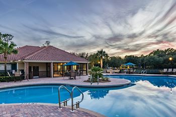 a swimming pool at a resort with a pool house