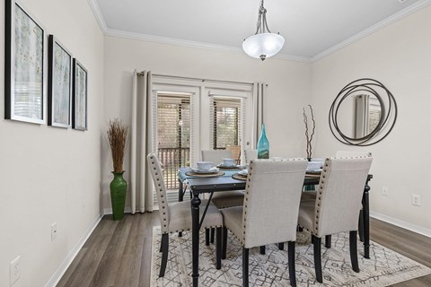 A dining room with a table set for four.