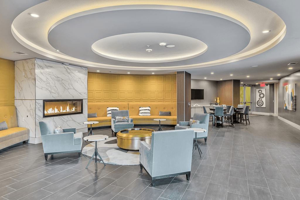 A modern living room with a fireplace and grey flooring.
