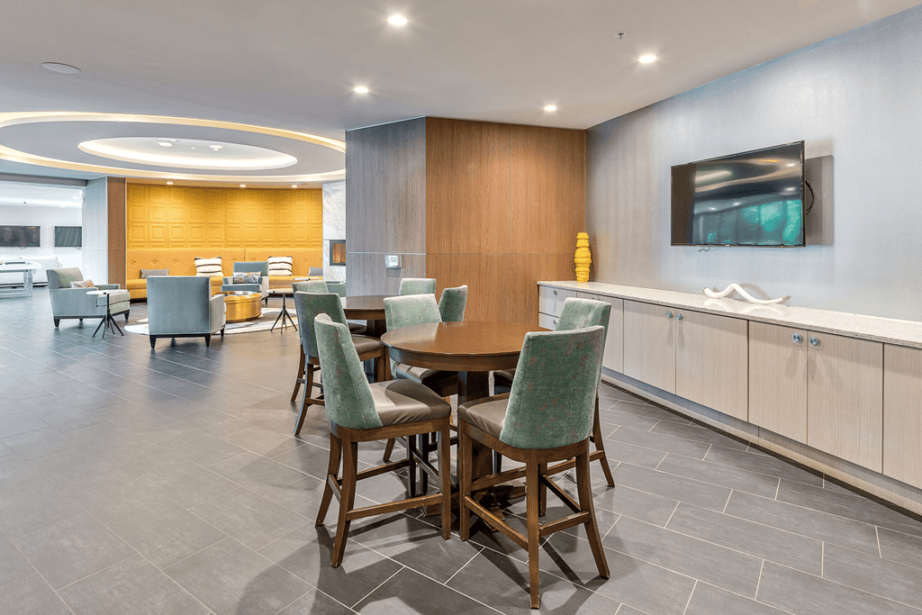 A modern dining room with a wooden table and chairs.