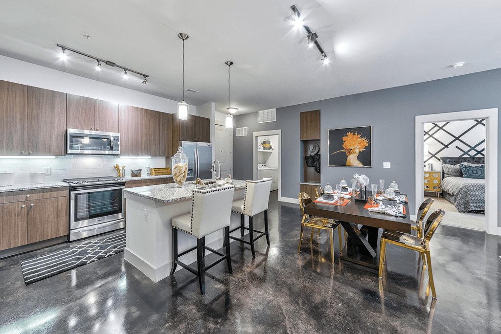 A modern kitchen with a dining table set for four.