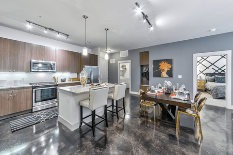 A modern kitchen with a dining table set for four.