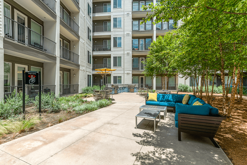 Apartment complex with a patio and couches.