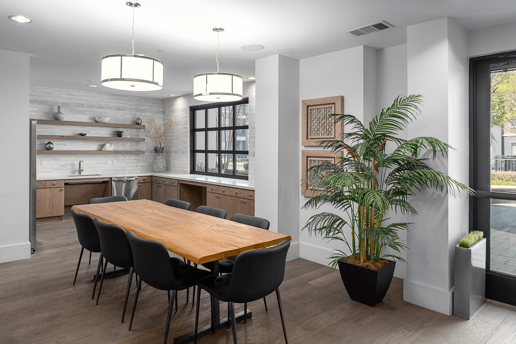 A dining room with a wooden table and chairs.