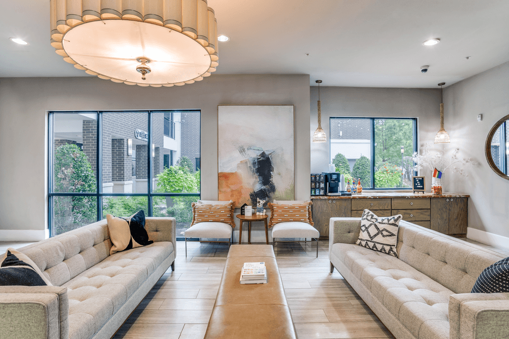 A modern living room with a large window and a fireplace.