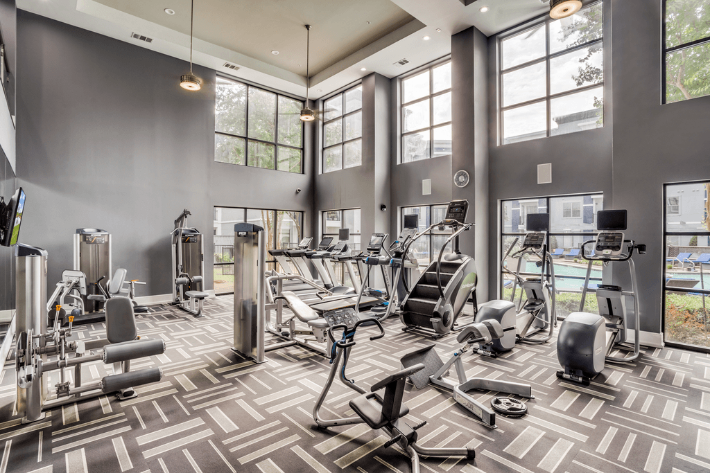 A gym with a variety of exercise equipment.