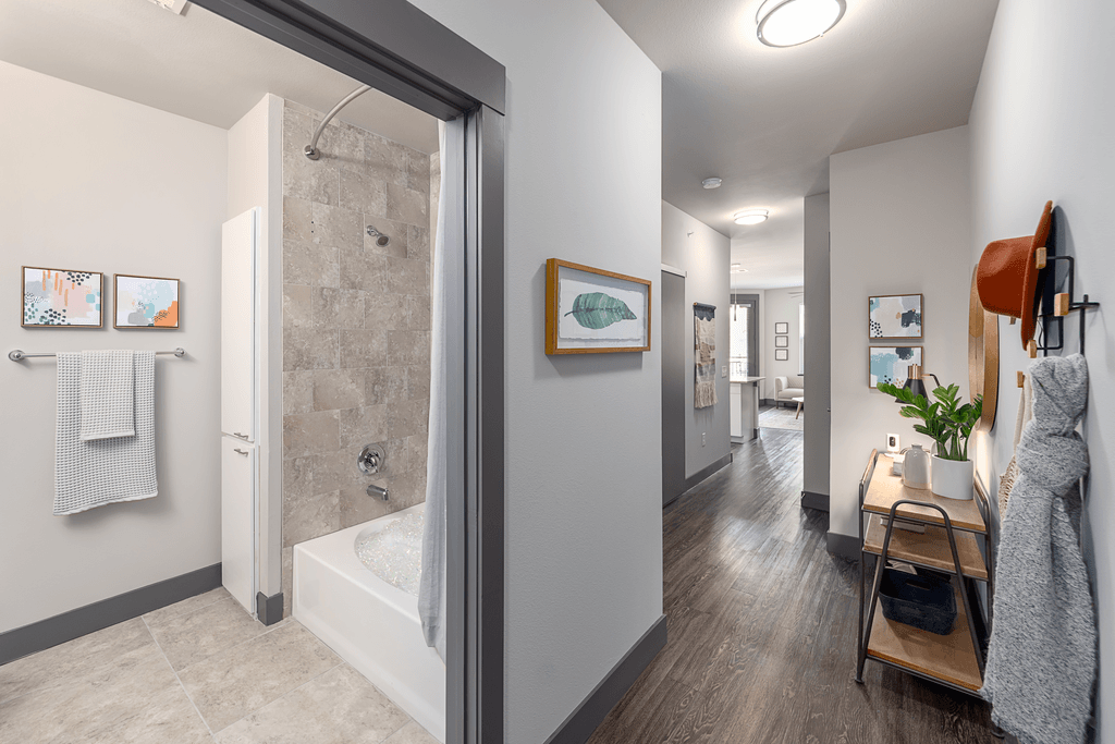 A bathroom with a walk-in shower and a towel rack.